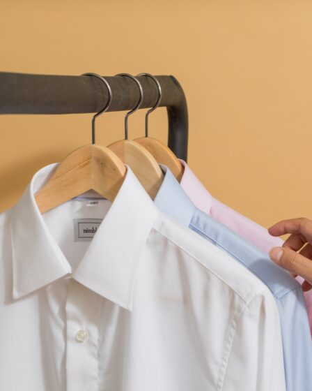 white button up shirt on black clothes hanger